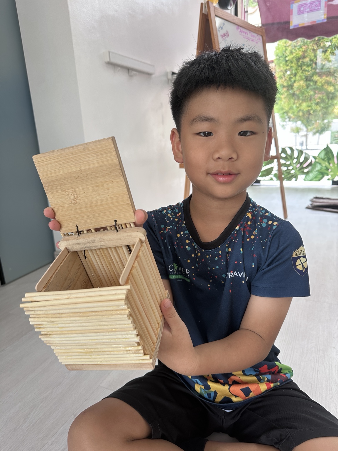 A child showing a handmade wooden box